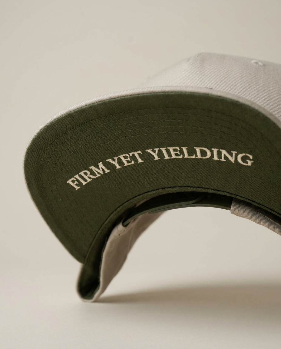 Tevilah stone and olive snapback — olive underbrim reading Firm yet yielding